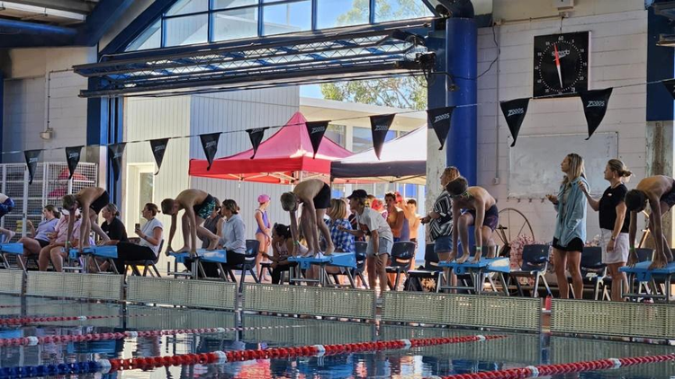 A group of people in a swimming pool AI-generated content may be incorrect.